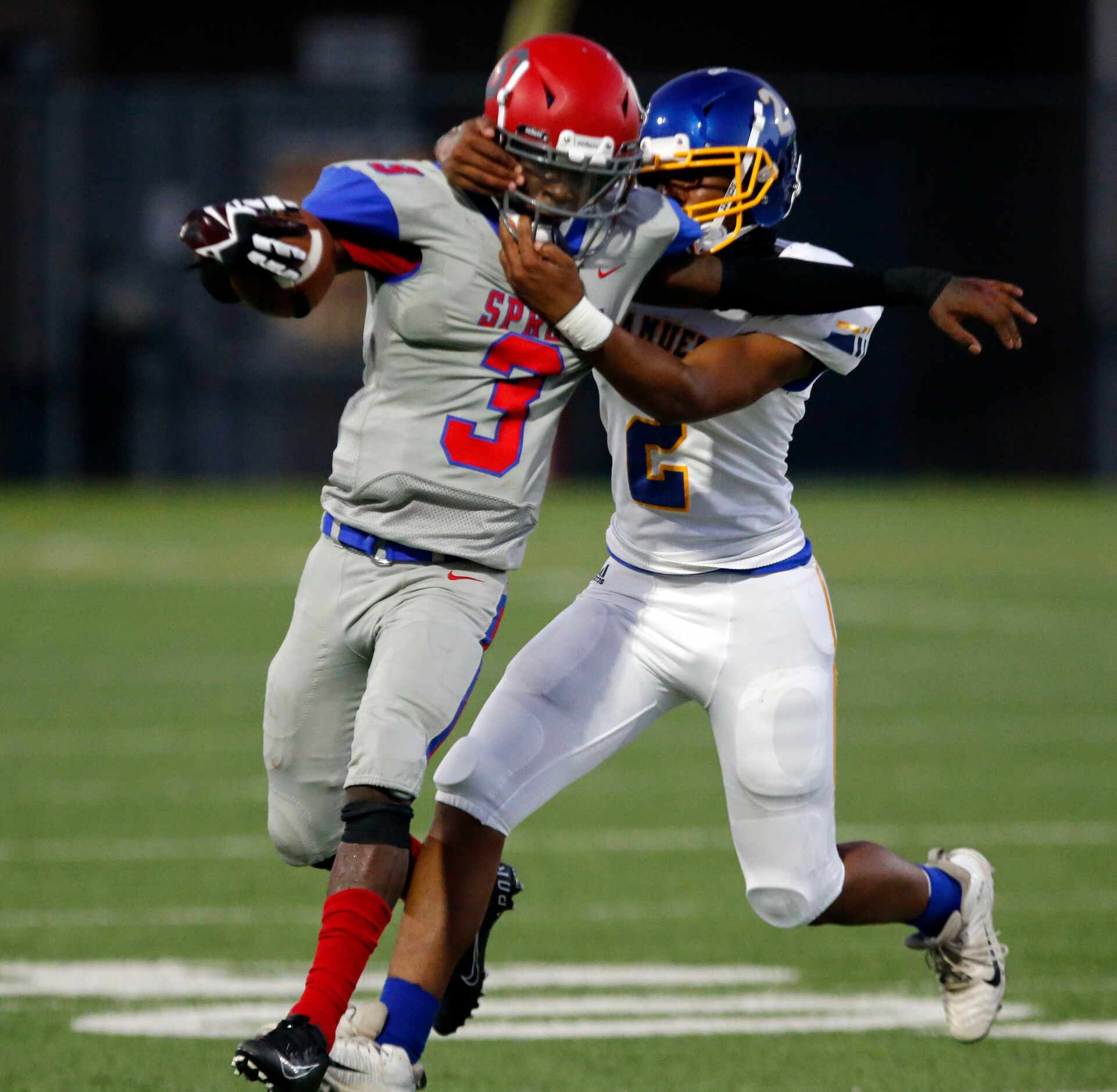 Spruce High QB Timad Cotton (3) is face masked by Samuell high defender Xzavion Beard (2)...