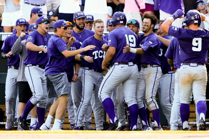 Teammates celebrate with TCU's Luken Baker (19) at the dugout after he hit a three-run home...