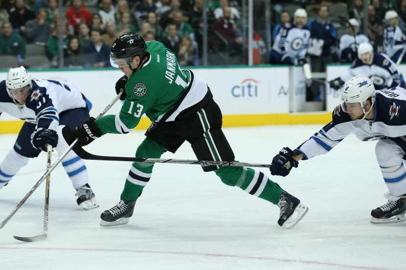 Dallas Stars center Mattias Janmark (13) shoots the puck in the first period during a...
