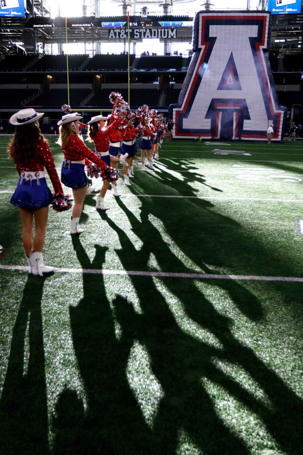 Members of the Allen High School's Tallenettes perform on the field prior to the Allen and...