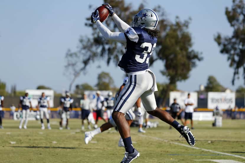 Dallas Cowboys cornerback Brandon Carr (39) comes down with a tipped pass for an...