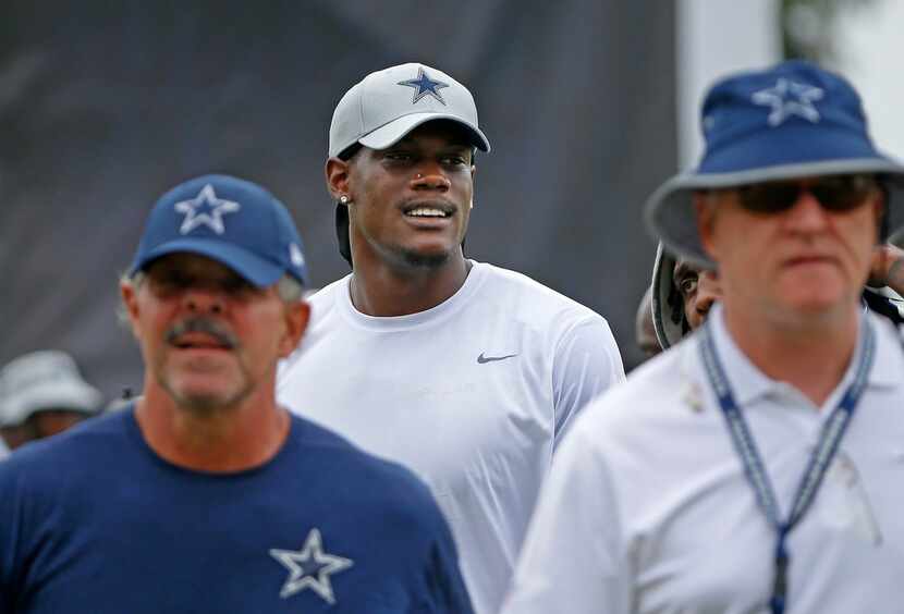 Cowboys defensive end Randy Gregory, center, walks off the field after a morning...