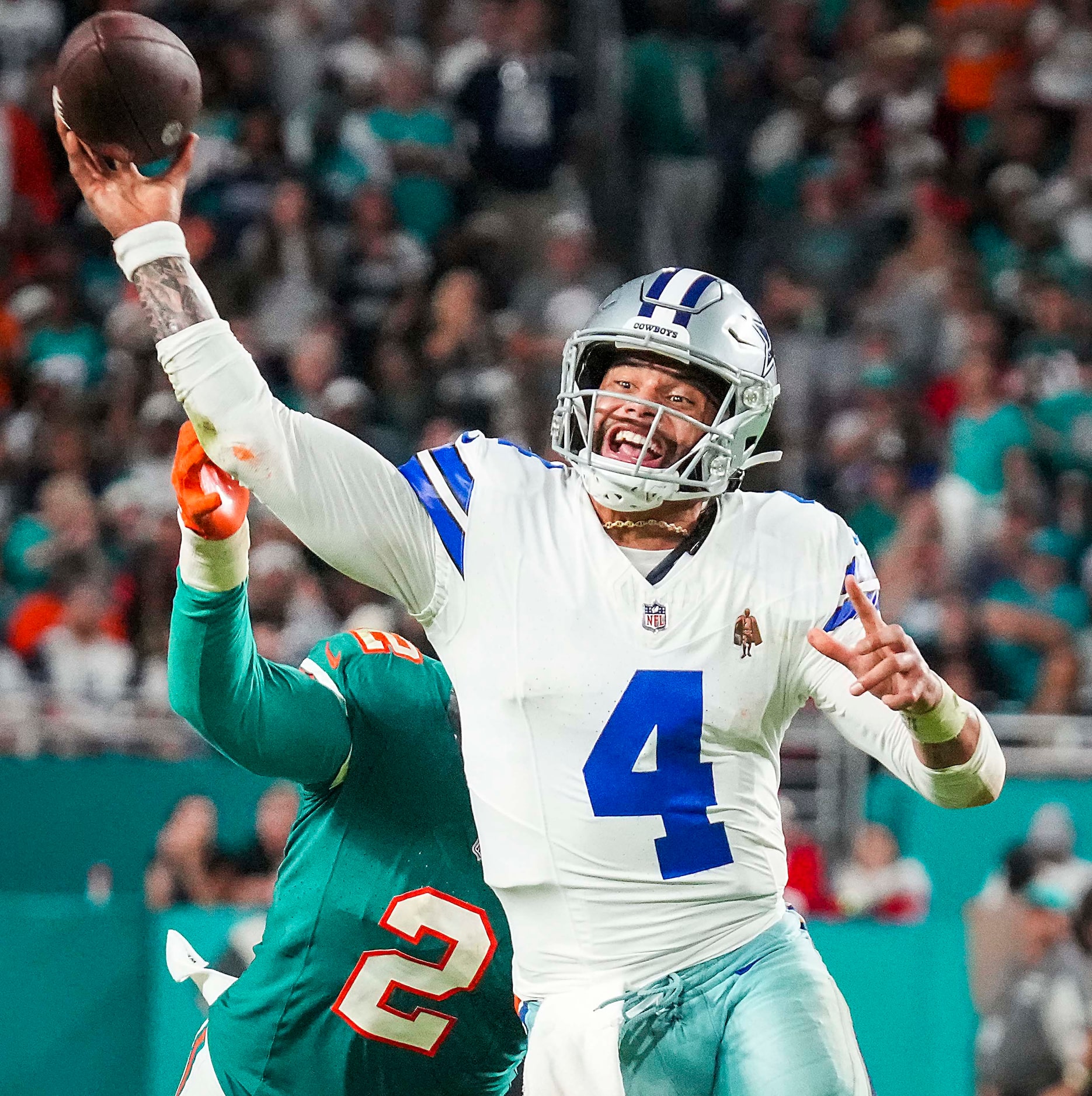 Dallas Cowboys quarterback Dak Prescott (4) throws a pass under pressure from Miami Dolphins...