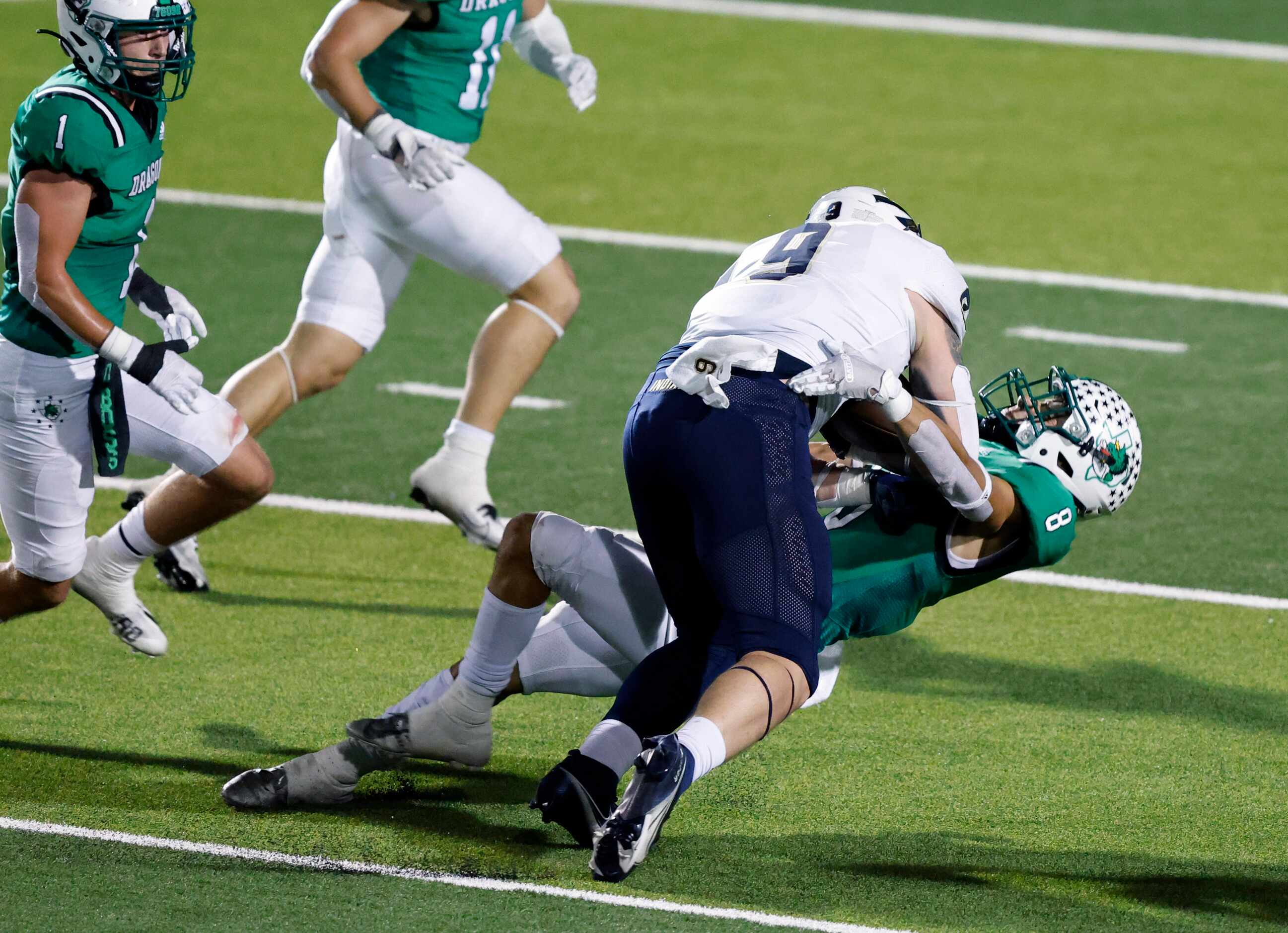 Keller tight end David Wagner (9) bulls over Southlake Carroll defensive back Carter High...