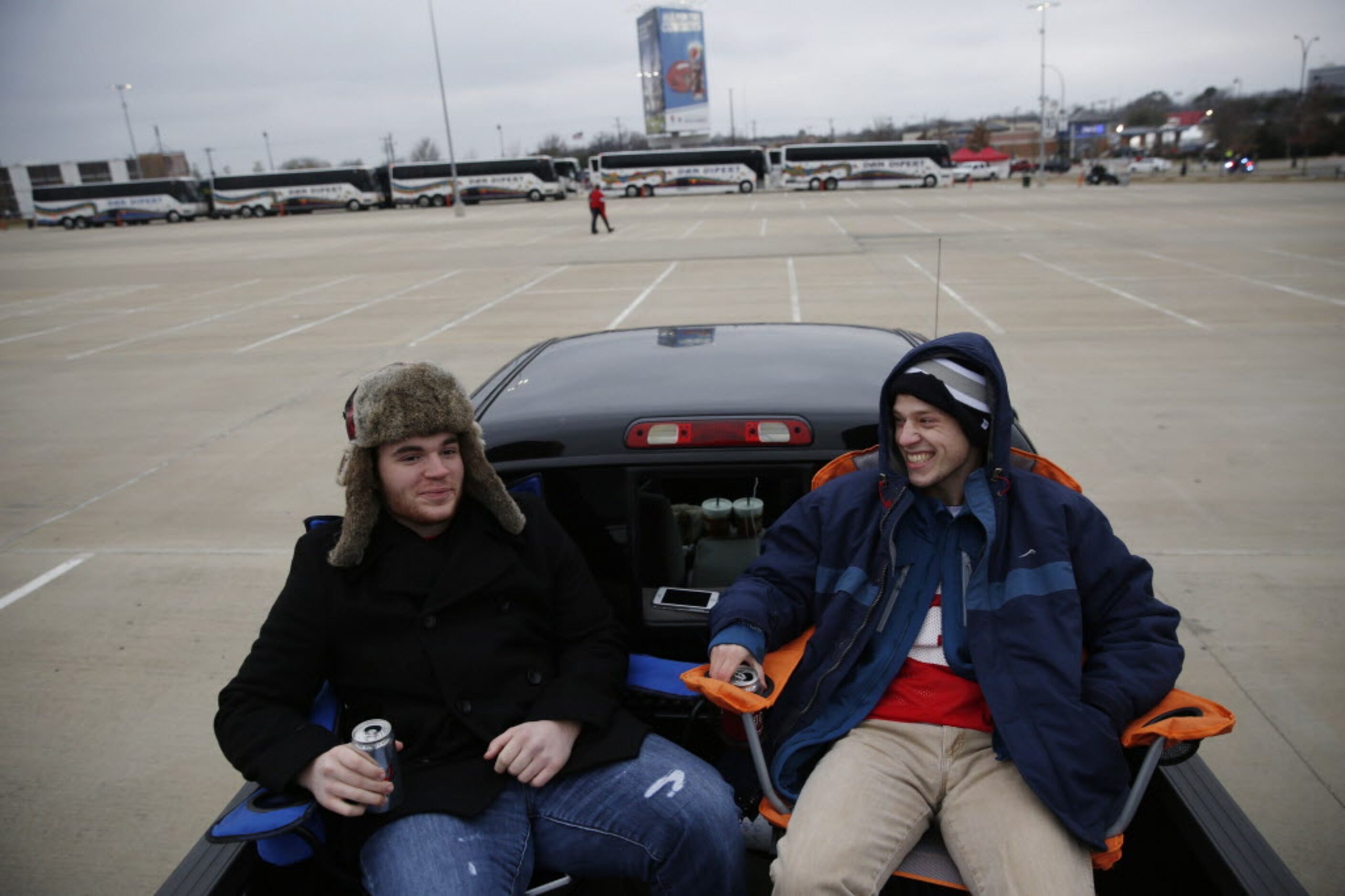 Ohio State Buckeyes Austin Appino (left) and Brian Kent, both of Dallas, tailgate before the...