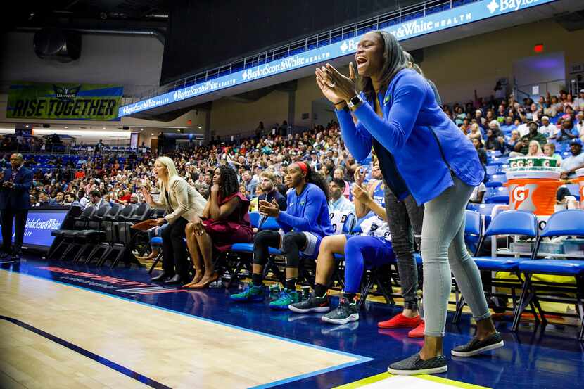 Dallas Wings forward Karima Christmas-Kelly cheers from the bench during the first half...