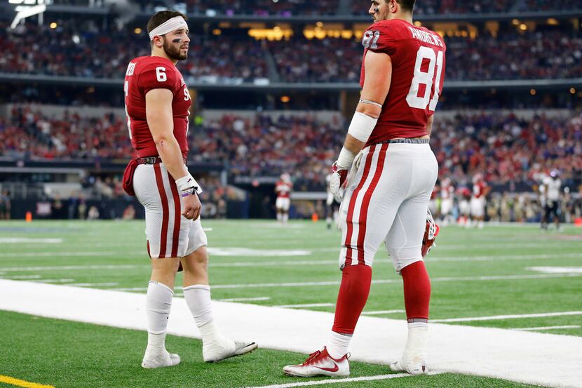 Oklahoma Sooners quarterback Baker Mayfield (6) visits with tight end Mark Andrews (81) on...