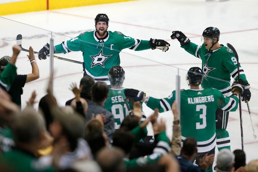 Dallas Stars forward Jamie Benn (14) is congratulated by teammate after scoring a goal...