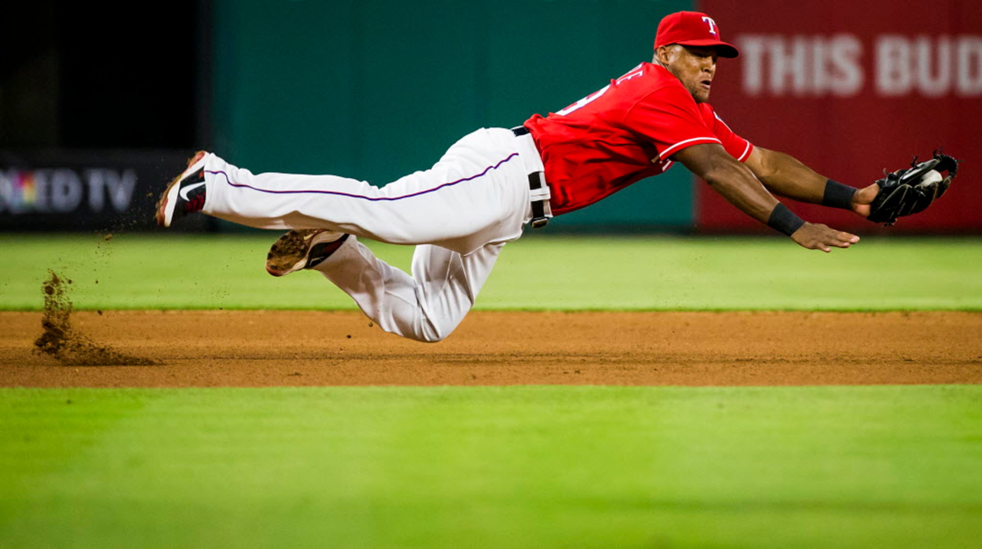 Texas Rangers third baseman Adrian Beltre makes a diving stop on a grounder by Pittsburgh...