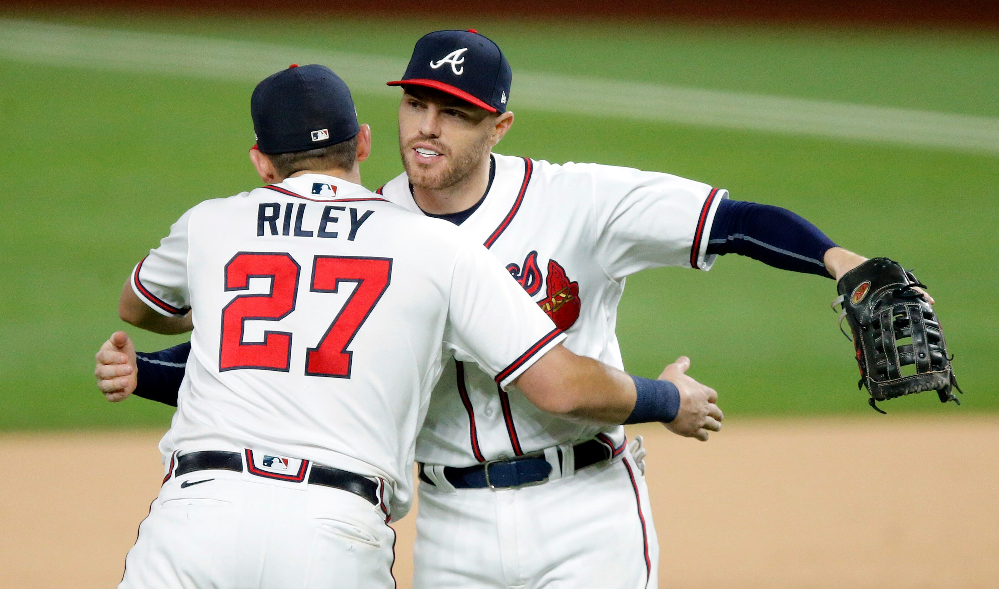 Atlanta Braves first baseman Freddie Freeman (5) and teammate Austin Riley (27) congratulate...