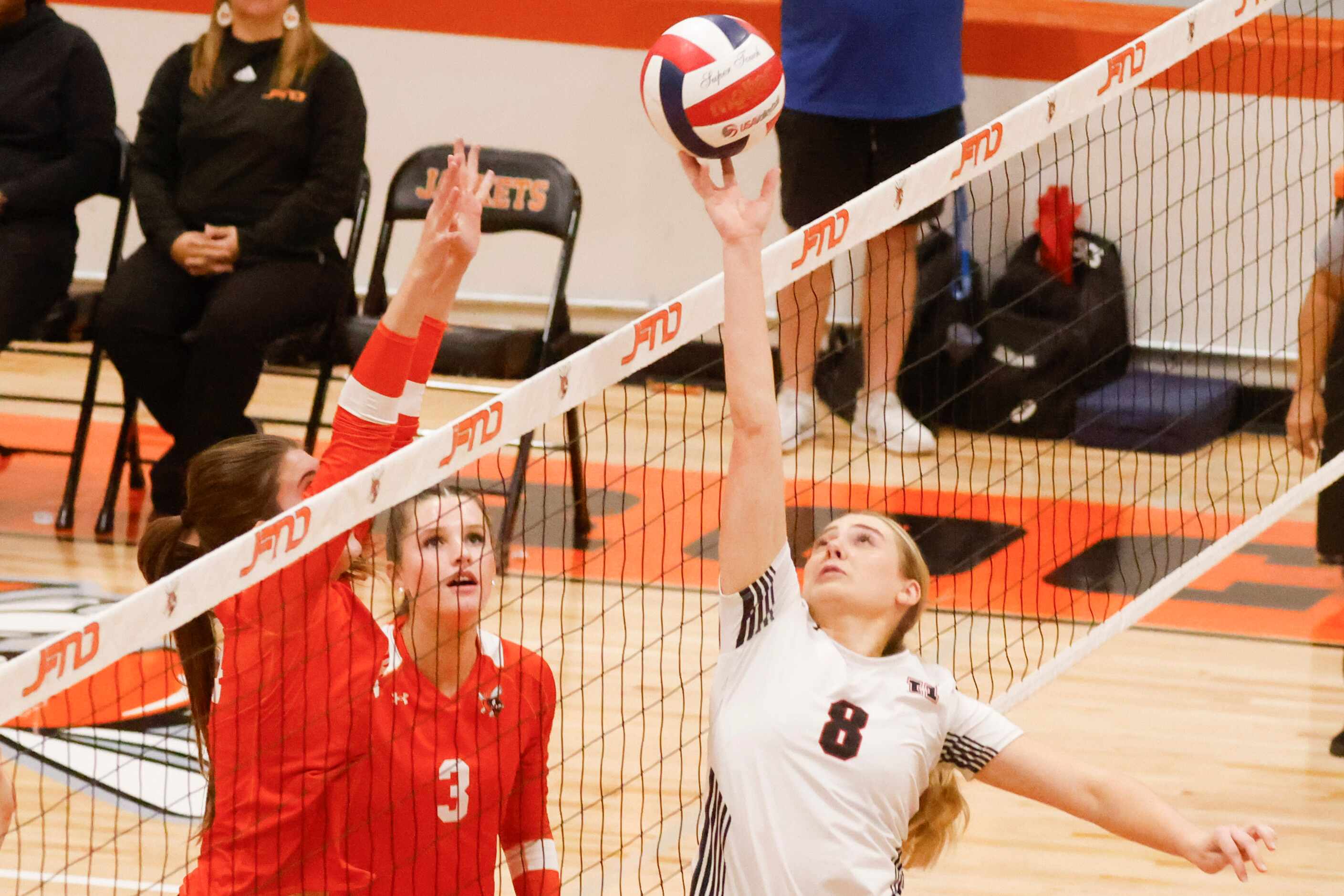 Rockwall heath’s Kenley Koetter (right) works against Rockwall high’s Harley Krause (3)...