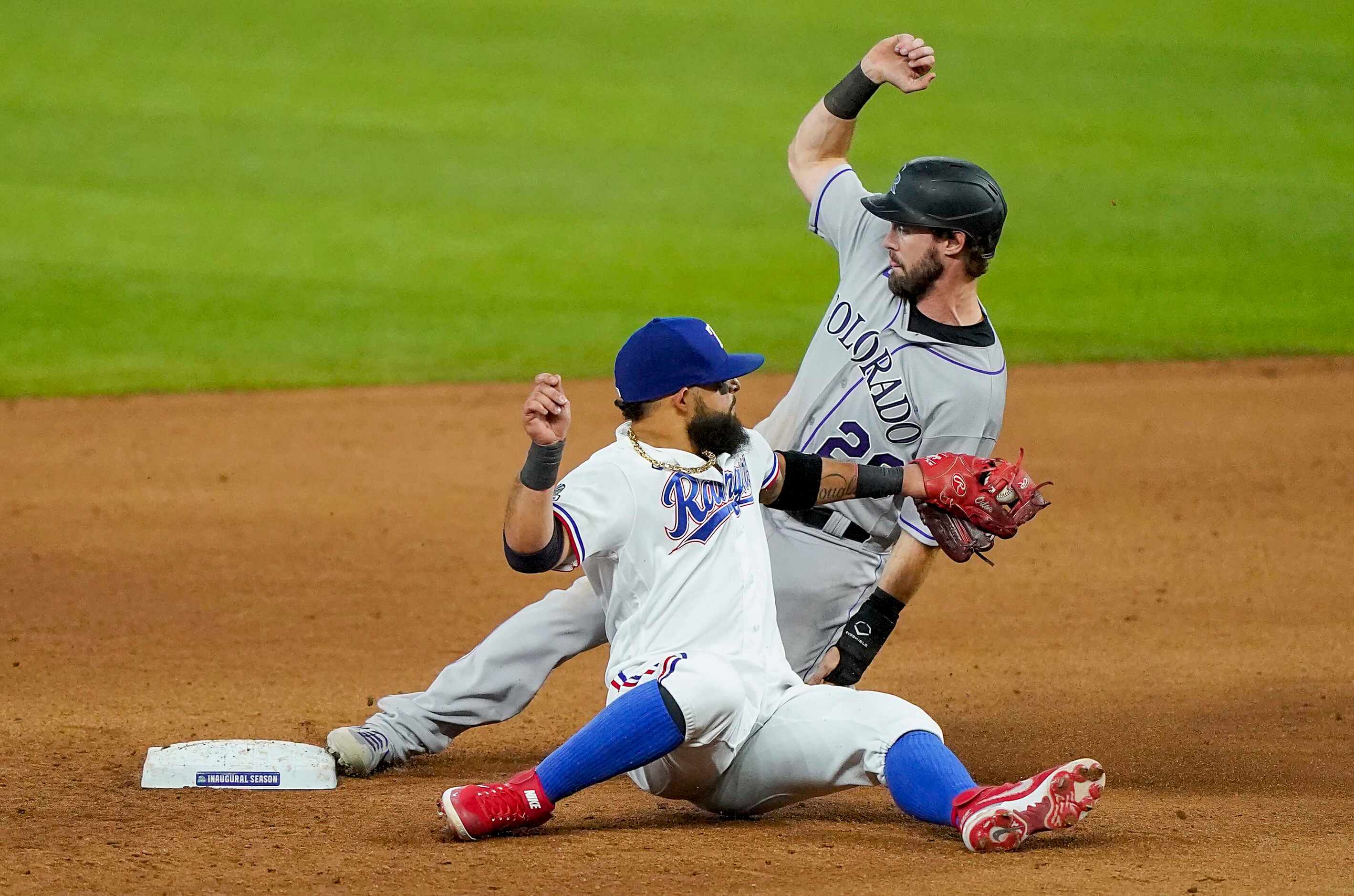 Colorado Rockies center fielder David Dahl slides past the tag from Texas Rangers second...