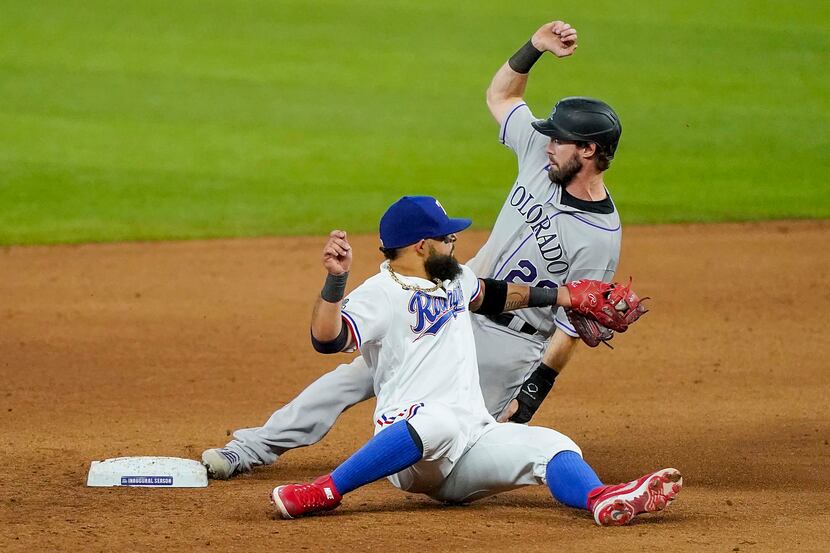 Colorado Rockies center fielder David Dahl slides past the tag from Texas Rangers second...