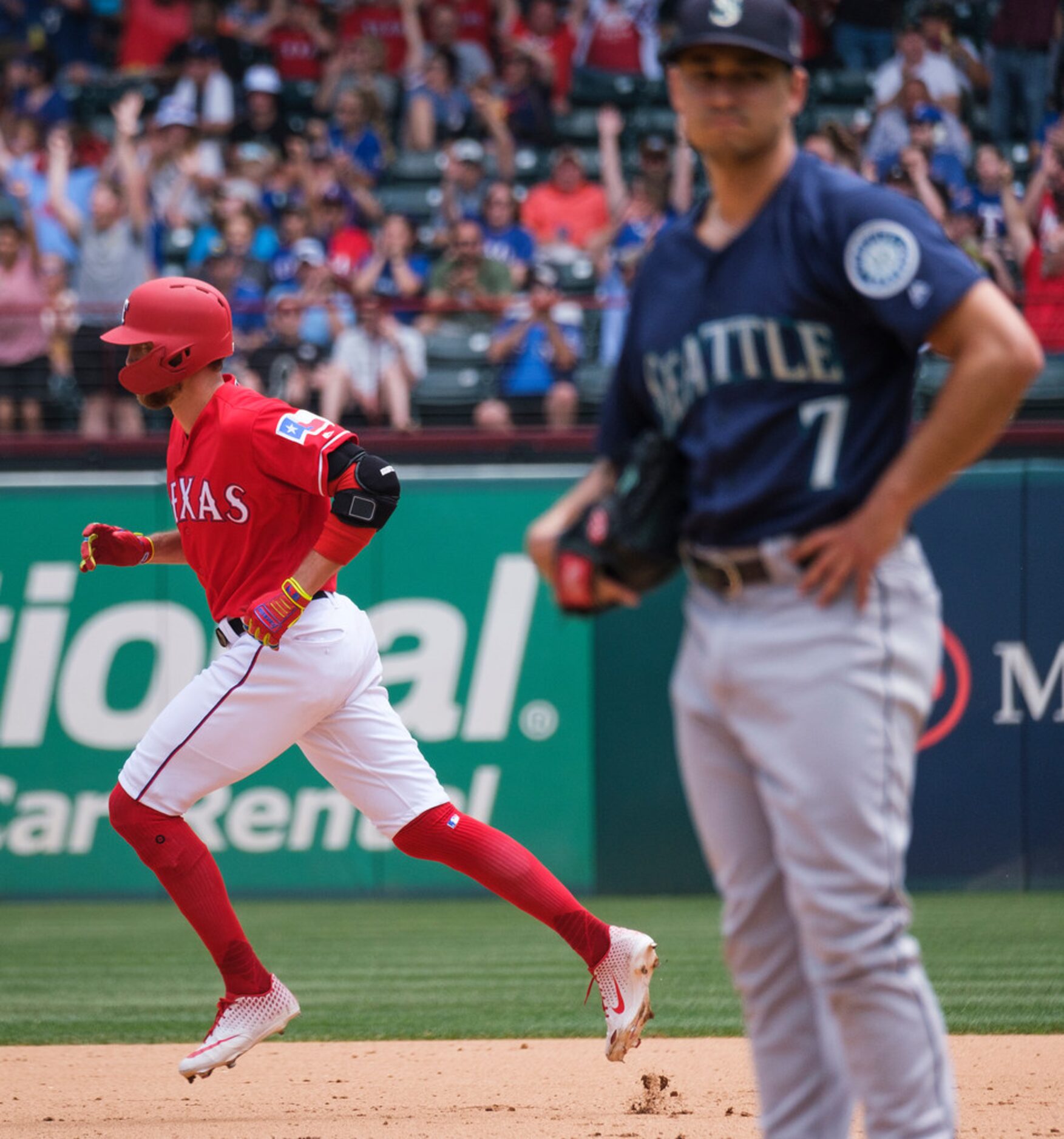 Texas Rangers designated hitter Hunter Pence rounds the bases after hitting a solo home run...