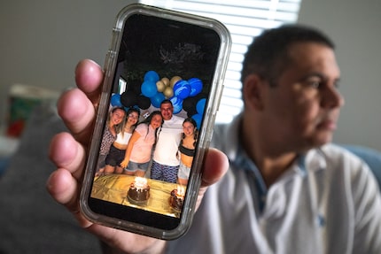 Venezuelan immigrant Nestor Cuevas, 40, shows an image of his wife, Carolina Mileno, and...