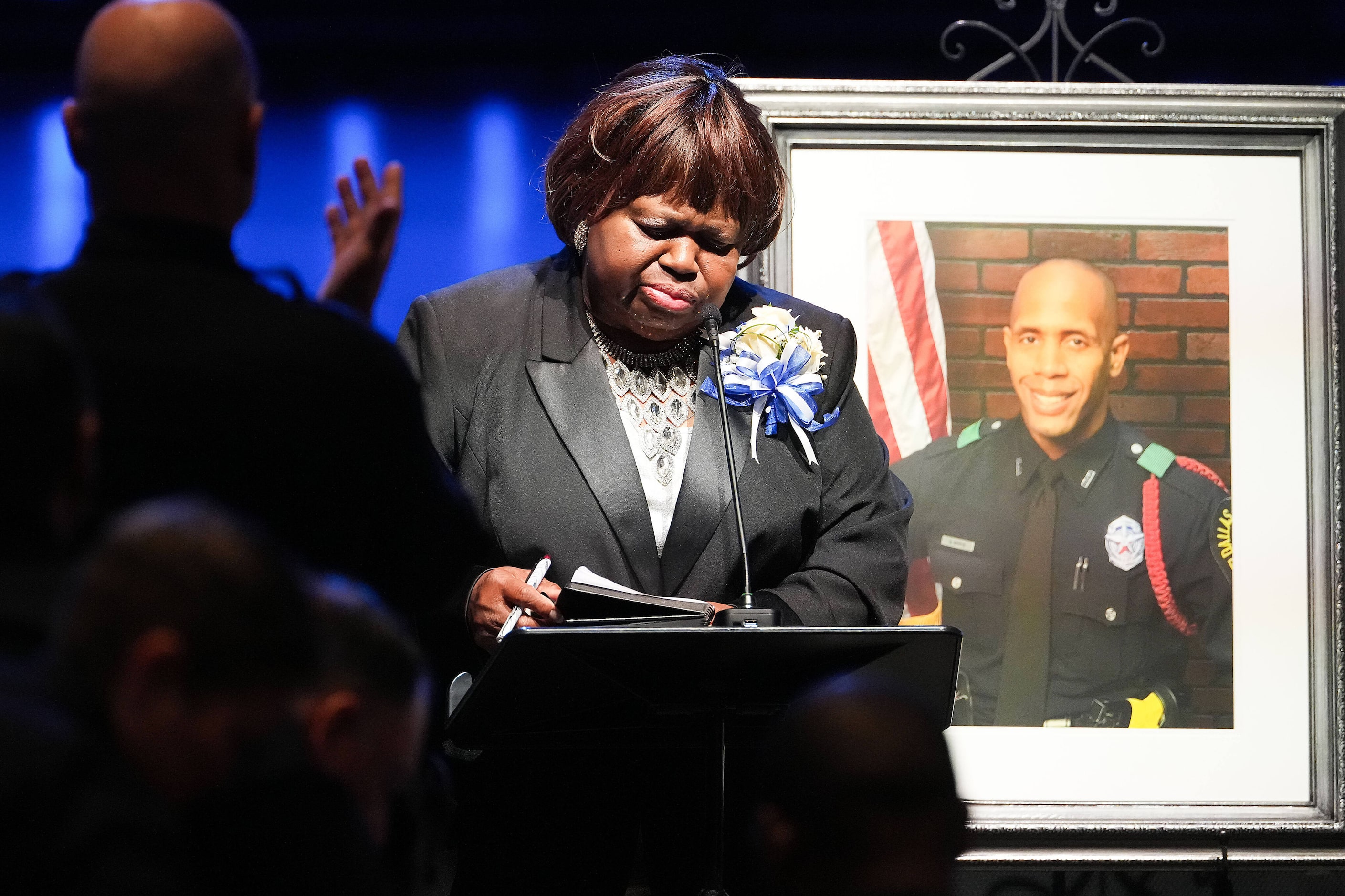 Dallas Police Chief Eddie García applauds as Cherie Jeffery speaks during funeral services...