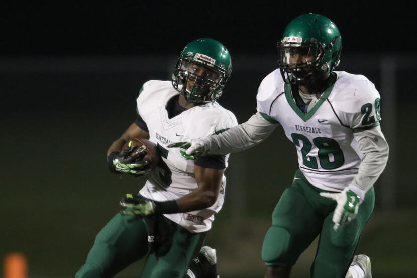 Kennedale running back Dailyn Wells (5) looks for running room as he follows the block of...