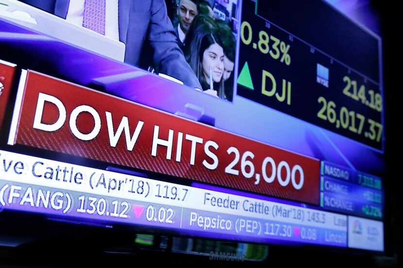 A television screen on the floor of the New York Stock Exchange headlines the Dow Jones...