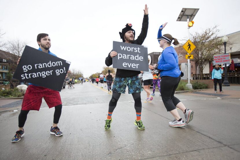 Andrew Alvarez, left, and Anthony Sequera (CQ), center, cheer on participants of the 45th...