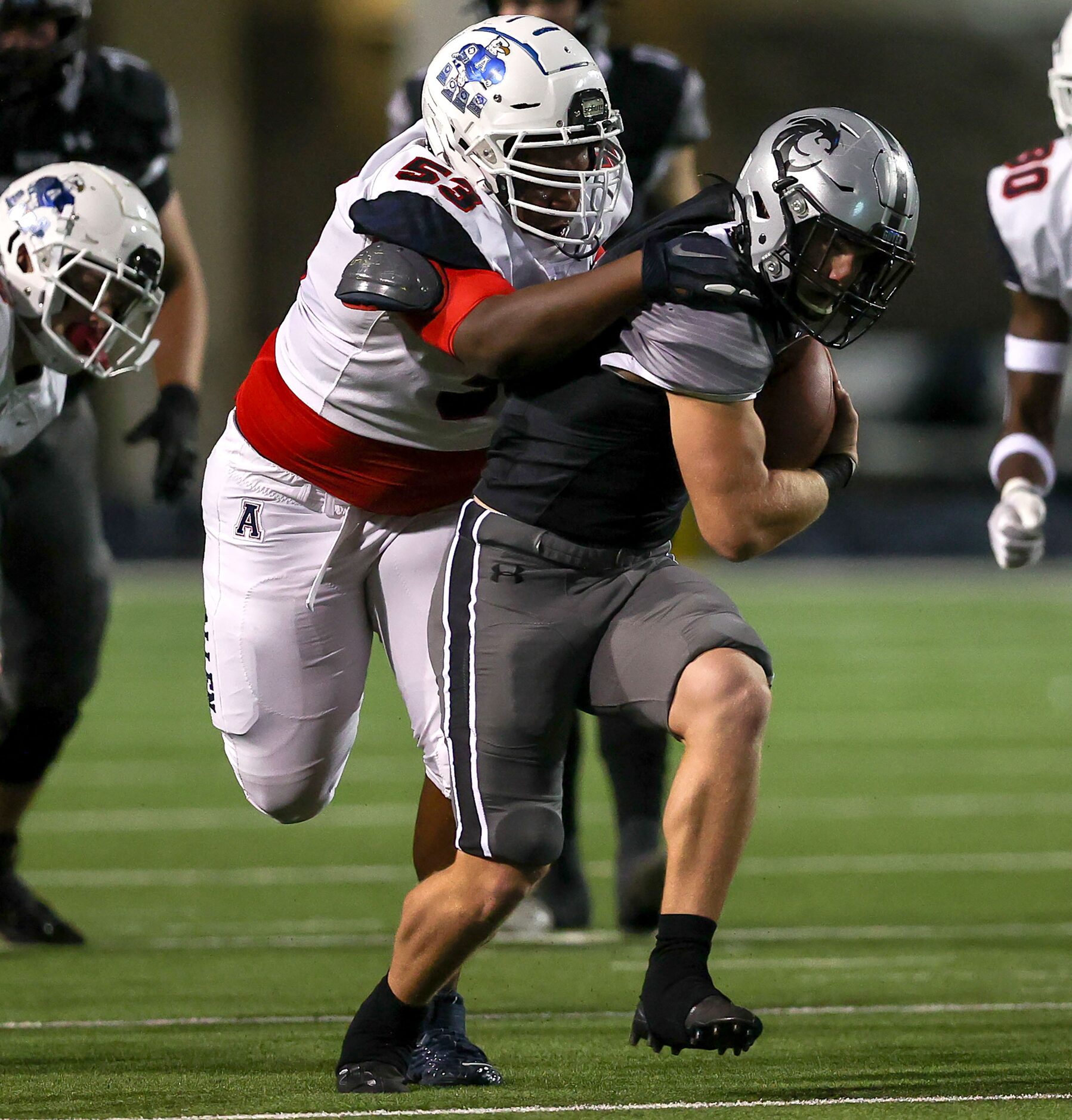 Denton Guyer running back Jackson Foster (16) gets dragged down by Allen defensive lineman...