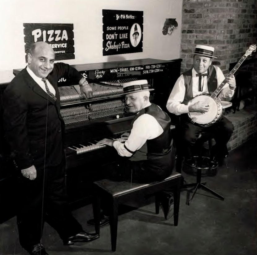 Andy Stasio (left), who opened the first Shakey's Pizza Parlor in DFW in the 1960s, posed...