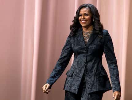 Former first lady Michelle Obama walks on stage during a stop on her book tour for...