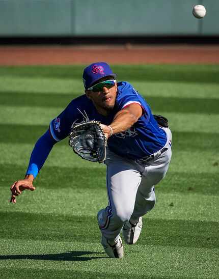 Texas Rangers center fielder Bubba Thompson makes a diving catch on a line drive off the bat...