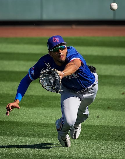 Texas Rangers center fielder Bubba Thompson makes a diving catch on a line drive off the bat...