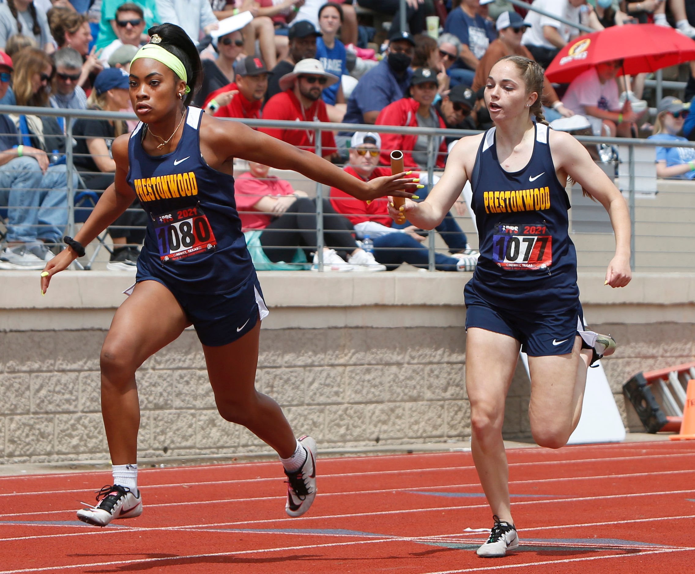 Plano Prestonwood's Jaden Matthews , right, passes the baton to teammate Hannah Stoutmire...