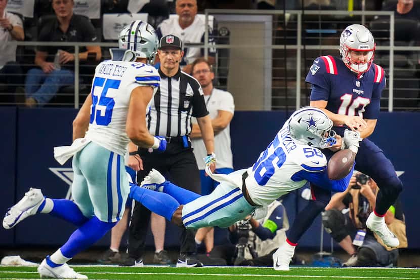 New England Patriots quarterback Mac Jones (10) fumbles as he is hit by Dallas Cowboys...