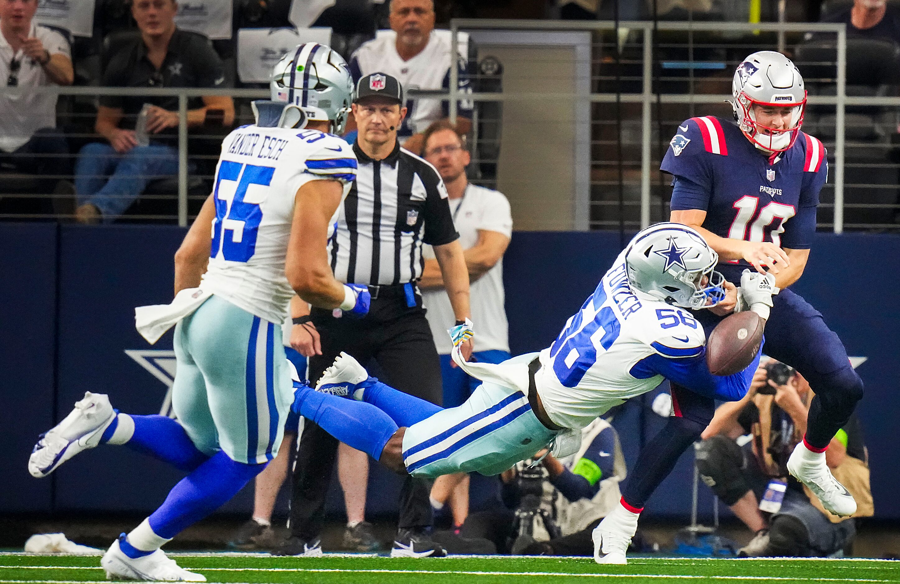 New England Patriots quarterback Mac Jones (10) fumbles as he is hit by Dallas Cowboys...