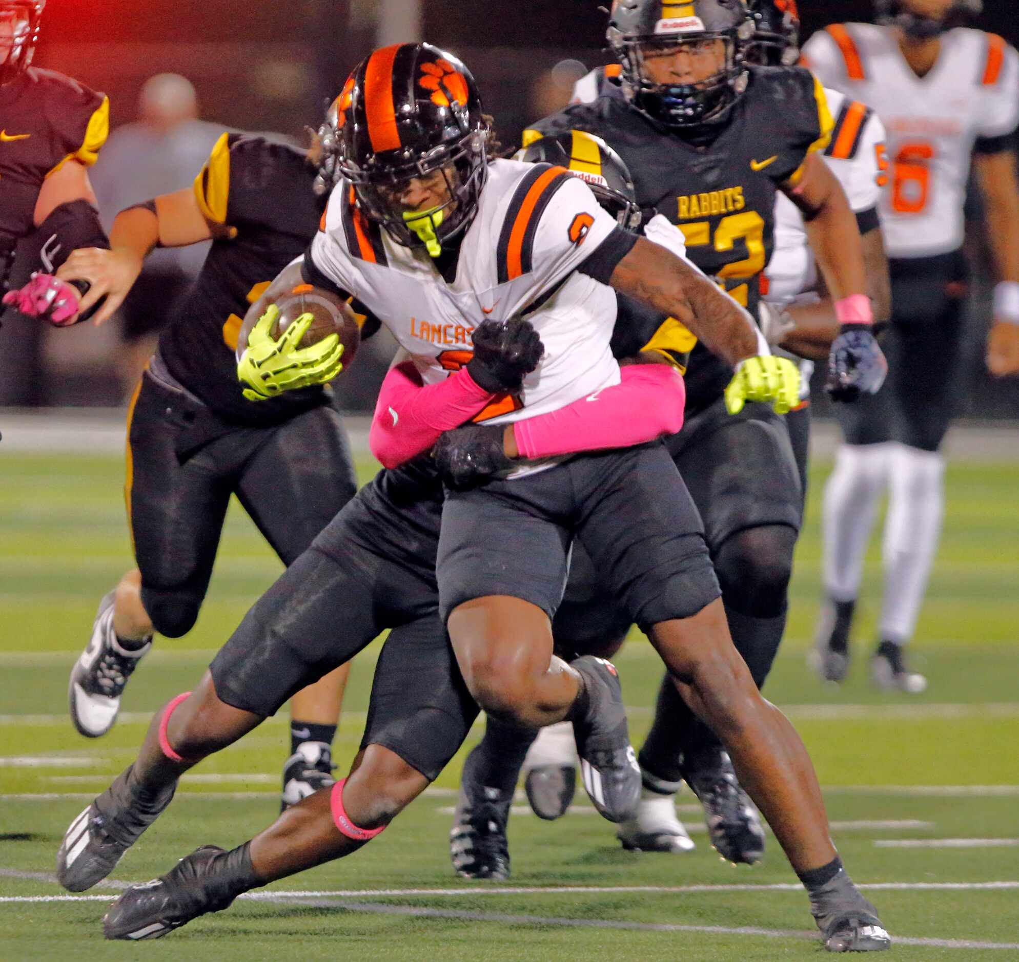 Lancaster high’s Kewan Lacy (2) picks up a first down in heavy traffic during the first half...