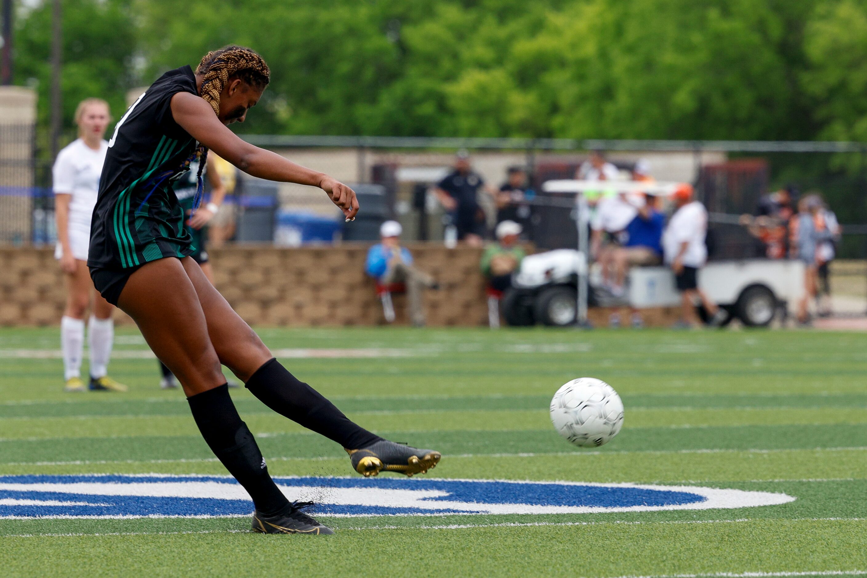 Southlake Carroll midfielder Zoe Matthews (20) shoots the ball during the first half of a...