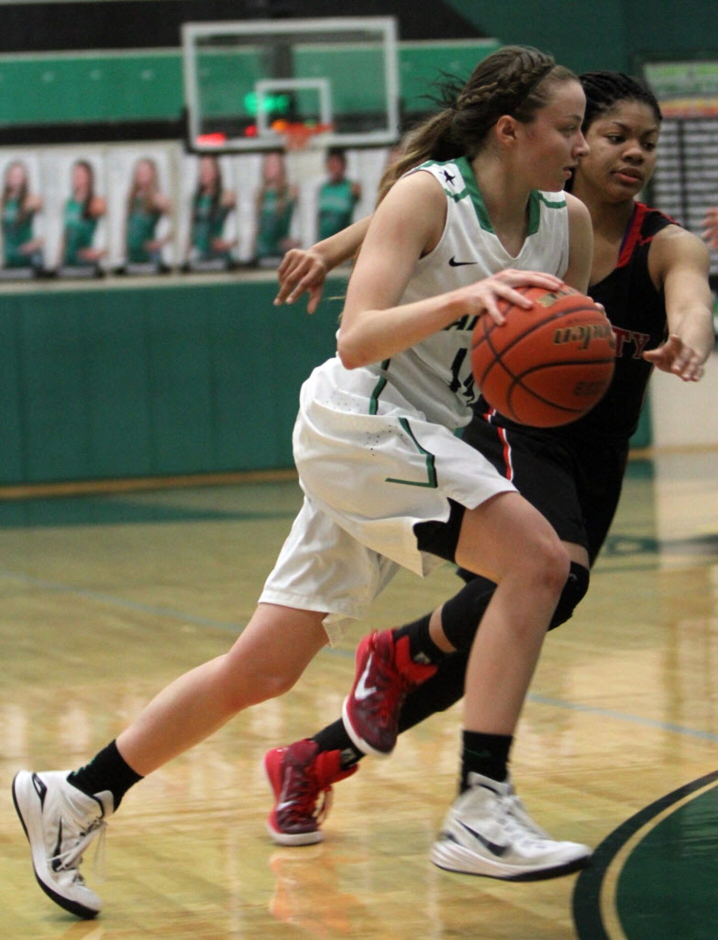 Southlake Carroll guard Kennedy Leonard (14) drives to the basket past the defense of Euless...