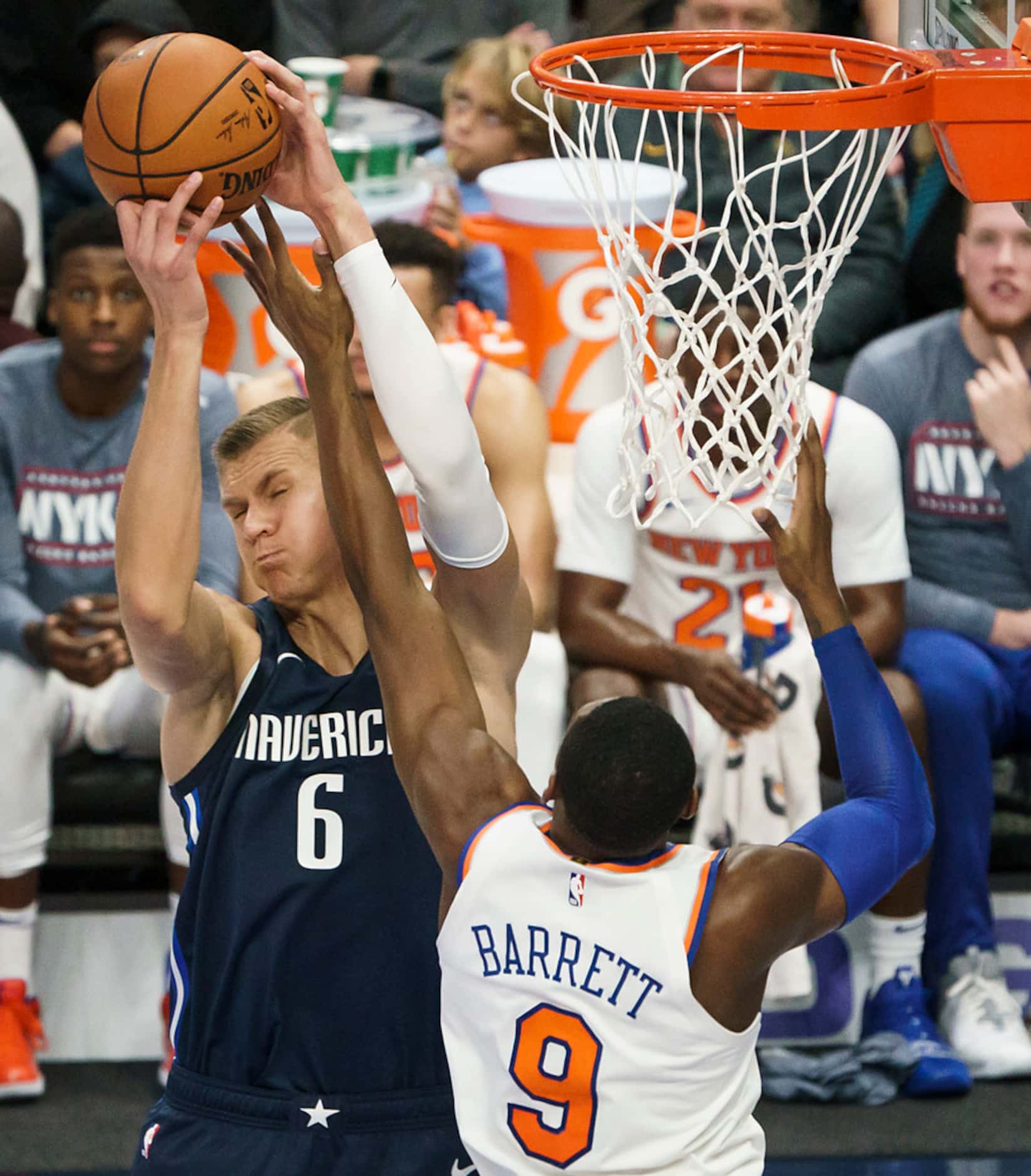 Dallas Mavericks forward Kristaps Porzingis (6) grabs a rebound from New York Knicks guard...