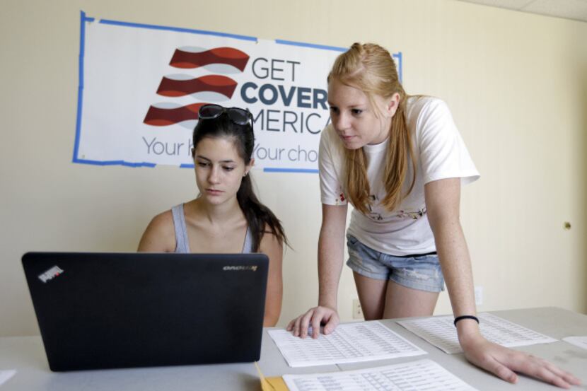 Ashley Hentze (left) of Lakeland, Fla., gets help signing up for health care from Kristen...