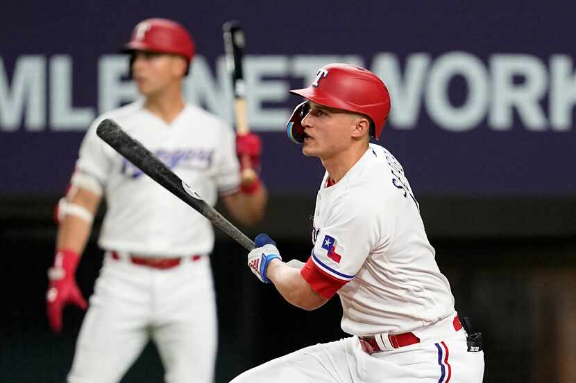 Texas Rangers' Corey Seager watches his RBI sacrifice fly against the Atlanta Braves during...