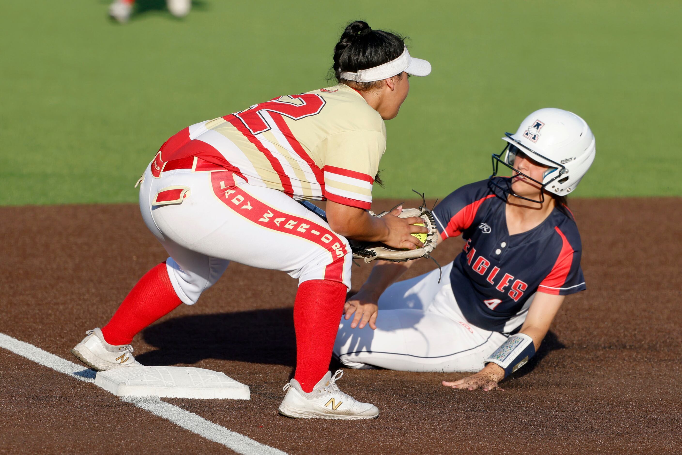 Allen’s Sami Hood (4) slides safely into 3rd under the tag of South Grand Prairie’s Emma...