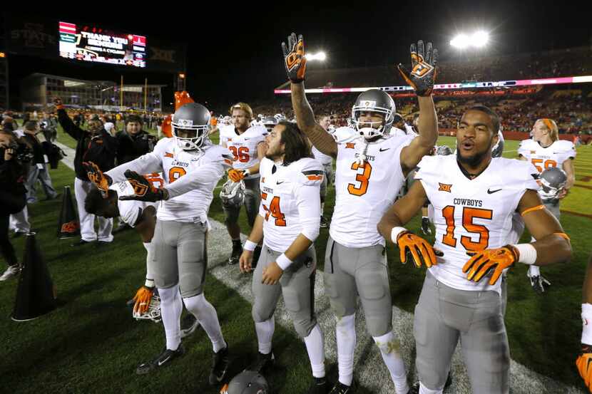 AMES, IA - NOVEMBER 14: The Oklahoma State Cowboys celebrate after their team defeated the...