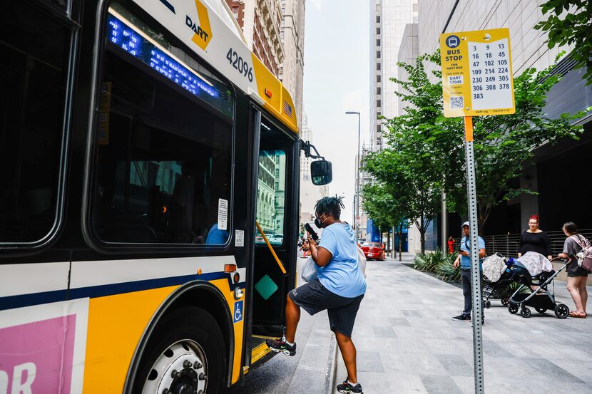 Denise Williams, a home healthcare worker, hops on the 13 bus at a bus stop on Commerce St...