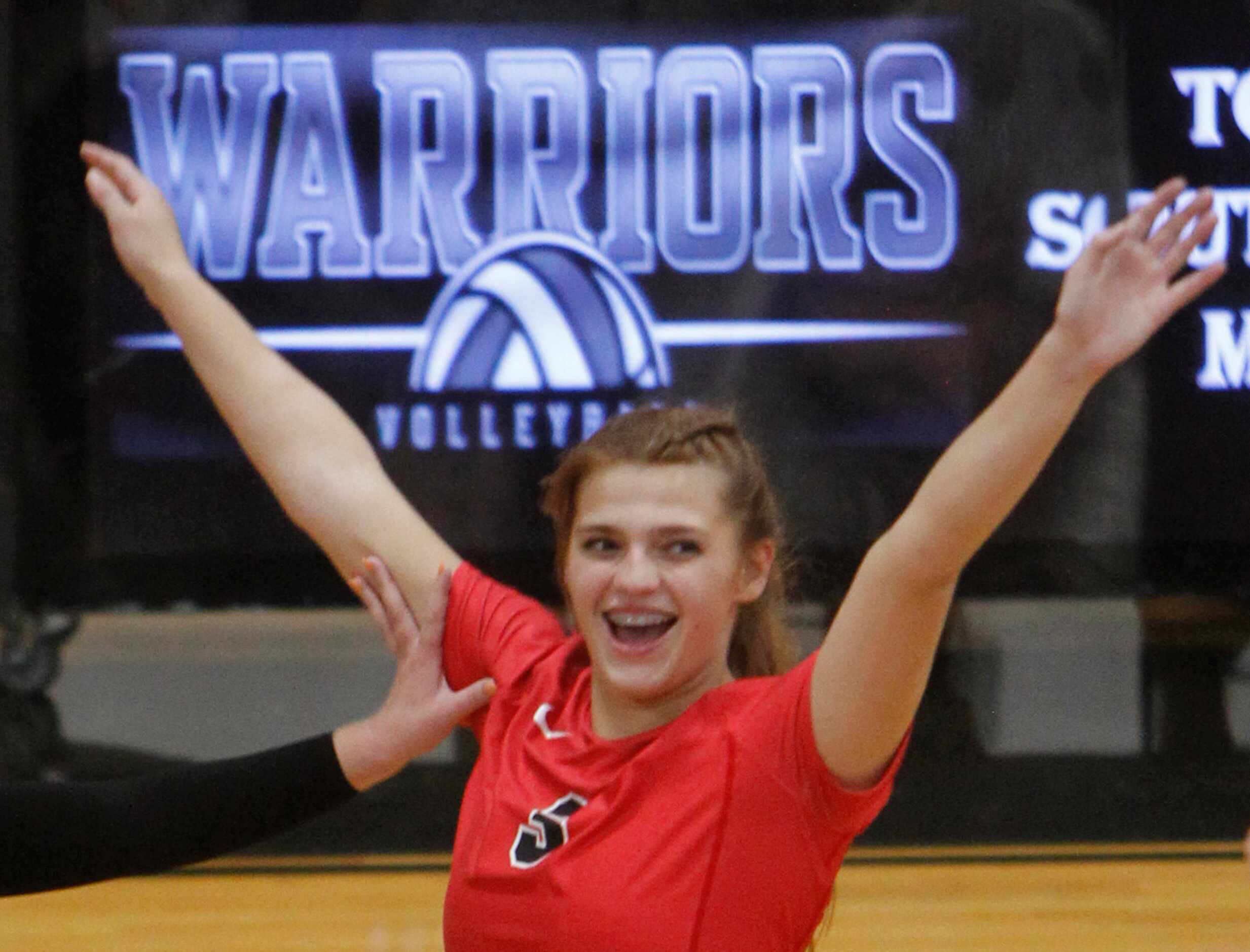 Arlington Martin's Zella Baresh (3) reacts after scoring in the second set of their match...