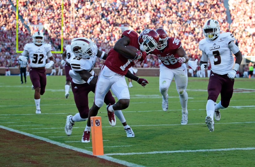 NORMAN, OK - SEPTEMBER 10 : Wide receiver Jarvis Baxter #1 of the Oklahoma Sooners is hit by...