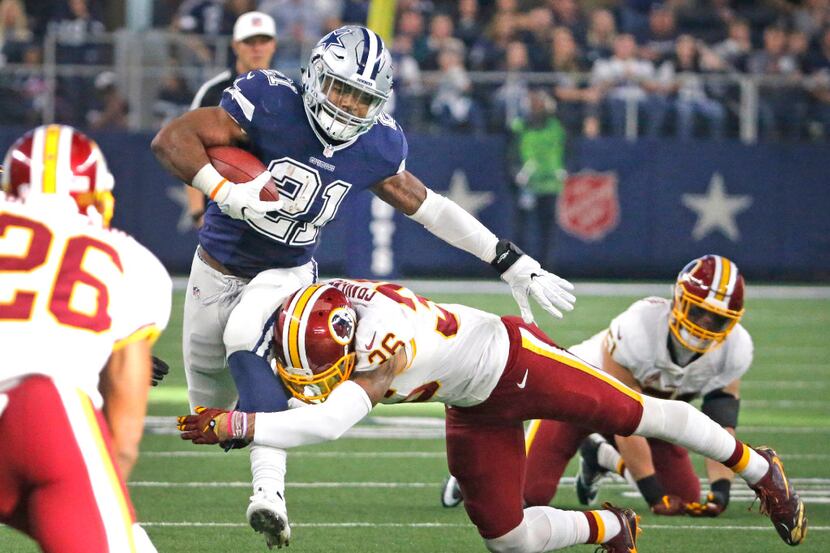 Dallas Cowboys running back Ezekiel Elliott (21) slices through the Redskins defense on a...