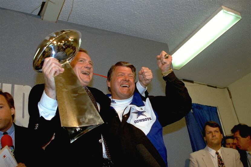 Dallas Cowboys head coach Jimmy Johnson, right, and Cowboys owner Jerry Jones, hold up the...