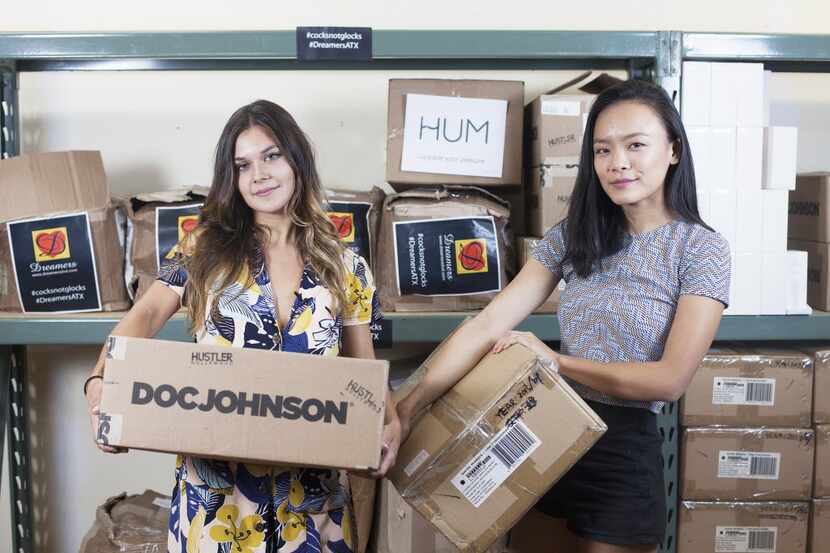 Ana Lopez (left) and Jessica Jin hold boxes filled with sex toys that were used Wednesday to...
