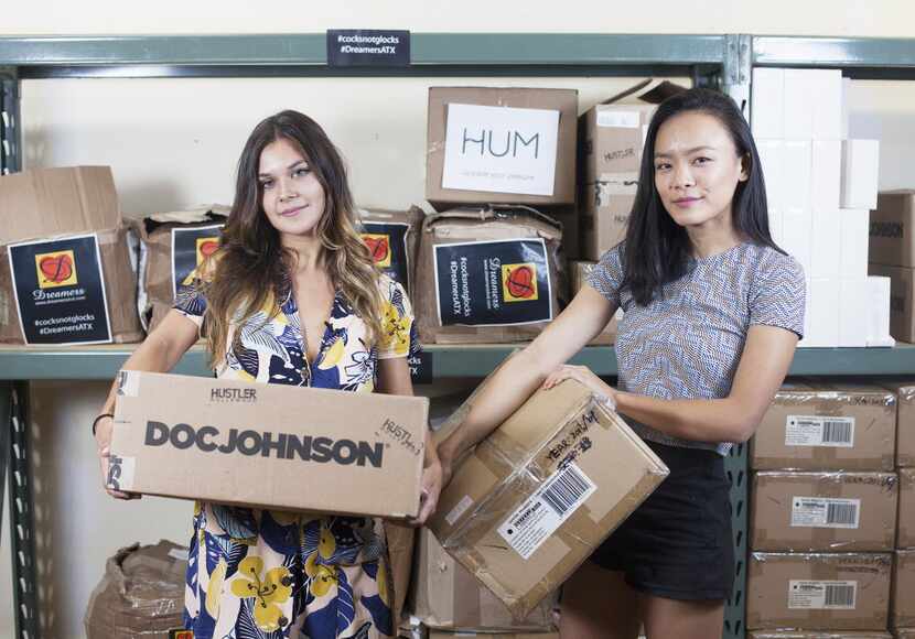 Ana Lopez (left) and Jessica Jin hold boxes filled with sex toys that were used Wednesday to...