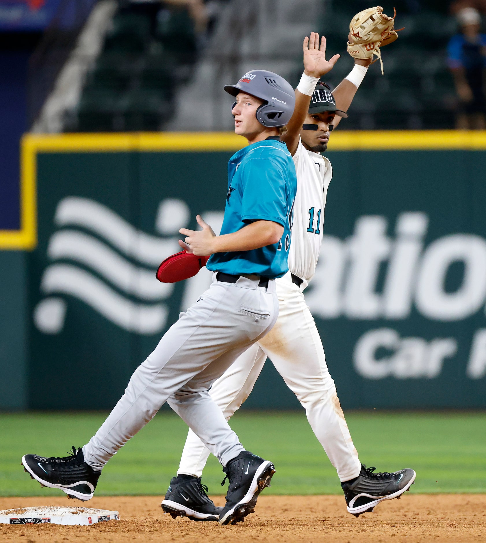 American League infielder Jamal George (11) celebrates after making the final out of...