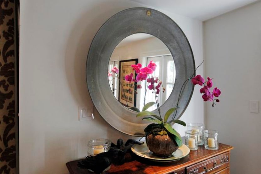 
The mirror and chest are part of the dining area, which is open to the large kitchen. 
