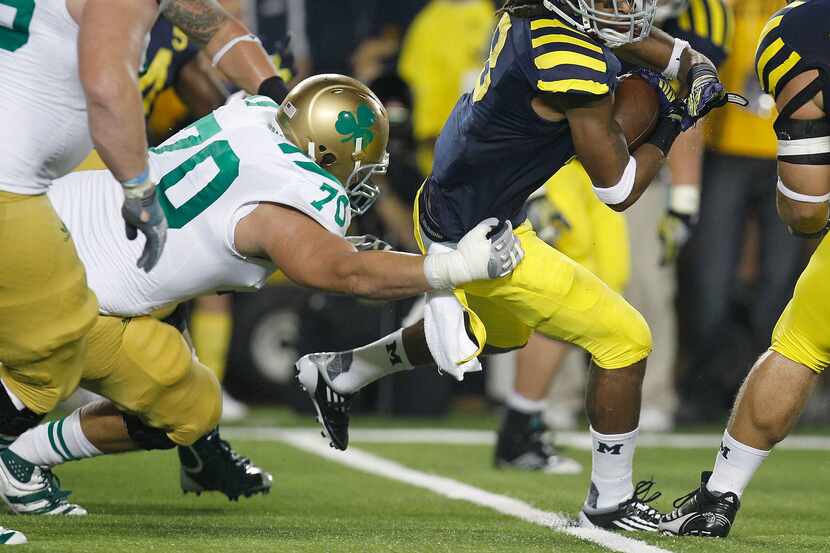 ANN ARBOR, MI - SEPTEMBER 10:  J.T. Floyd #8 of the Michigan Wolverines tries to avoid the...