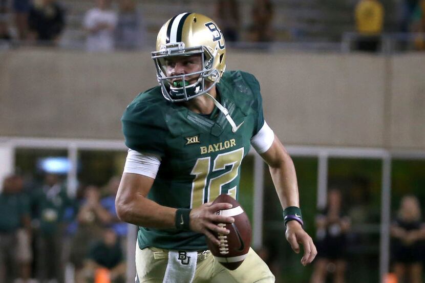Baylor quarterback Charlie Brewer scrambles against West Virginia during the second half of...